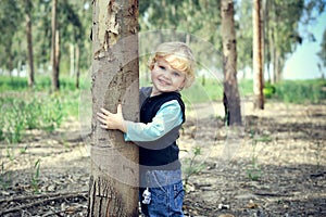 Boy Hugs eucalyptus tree