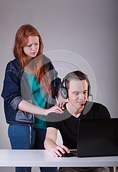 Boy ignoring girlfriend while playing computer games