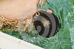 Boy in the indoor public pool. Child with swimmng goggles.