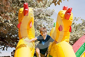 Boy in an inflatable toy house in a park