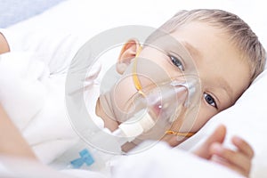 Boy with an inhaler mask - respiratory problems