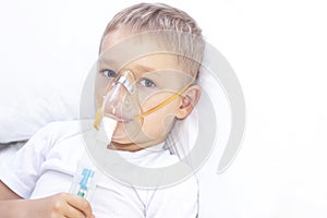 Boy with an inhaler mask - respiratory problems