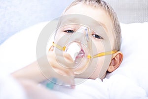 Boy with an inhaler mask - respiratory problems