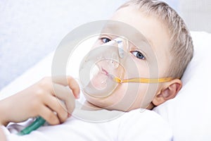 Boy with an inhaler mask - respiratory problems