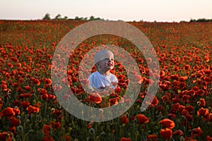 Boy inside red poppy field
