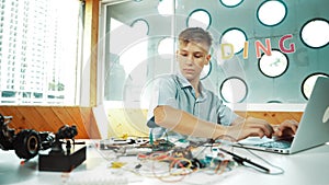 Boy inspect or learning to use electronic tool to fix car model. Edification.