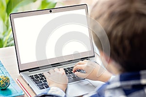 Boy on the internet with laptop computer doing homework