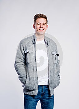 Boy in jeans and jacket, young man, studio shot