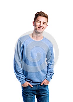 Boy in jeans and sweater, young man, studio shot