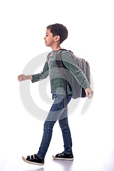 The boy in a jeans and t-shirt Ñ„Ñ‚Ð² satchel goes to school