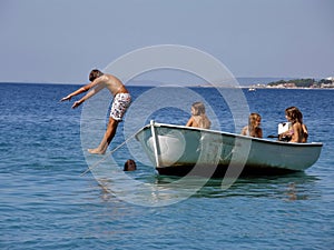 Boy jump from the boat into the sea