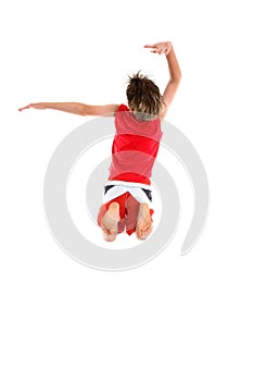 Boy jumping arms in grande pose.