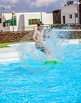 Boy jumping in the blue pool