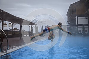 Boy Jumping In The Blue Pool, Children jump in the pool