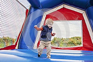 Boy jumping in Bounce house
