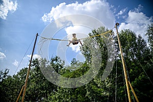 The boy is jumping on a bungee trampoline. A child with insuranc