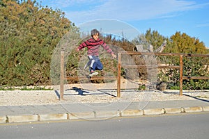 Boy Jumping A Fence