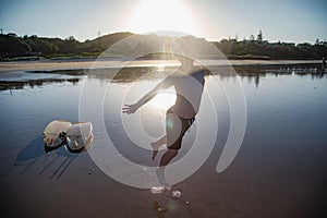 Boy jumping in the golden afternoon light on a Coffs Harbour beach, summer in Australia