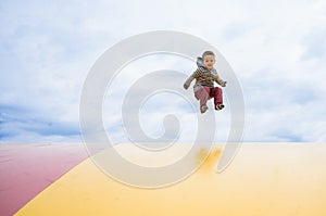 Boy jumping high on a outdoor trampoline