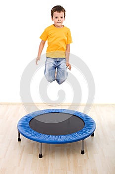 Boy jumping high on trampoline