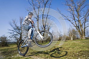 Boy jumping with his dirt bike