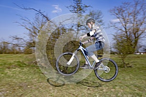 Boy jumping with his dirt bike