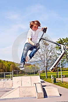 Boy jumping with his scooter