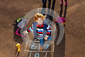 Boy jumping on hopscotch game