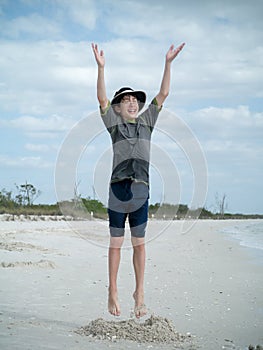 Boy Jumping for Joy On the Beach