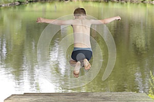 Boy jumping in a lake