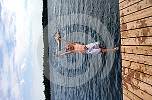 Boy jumping into lake