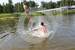 Boy jumping into lake