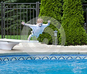 Boy jumping into pool