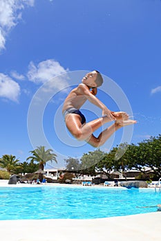 Boy jumping into the pool