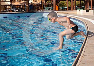 Boy jumping into the pool