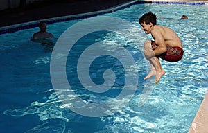 Boy jumping in the pool