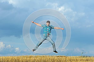 Boy jumping, running against blue sky