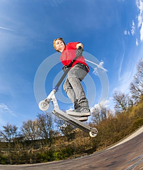 Boy jumping with a scooter