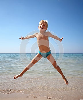 Boy jumping on a sea