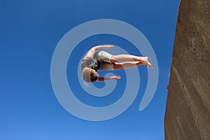 Boy Jumping Somersault Blue Parkour