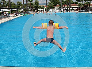 Boy jumping in swimming pool