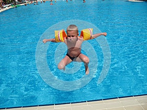 Boy jumping in swimming pool