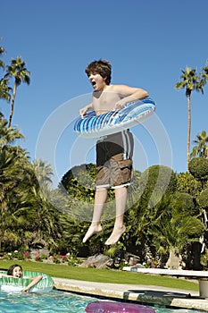 Boy Jumping Into Swimming Pool