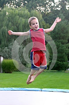 Boy Jumping on Trampoline