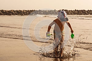 Boy jumping at tropical beach. Jumping into the air. Have a fun vacation. Sea recreation