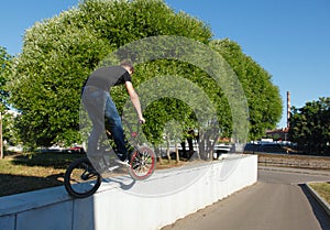 Boy jumping from wall on bmx