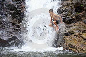 Boy jumping into water