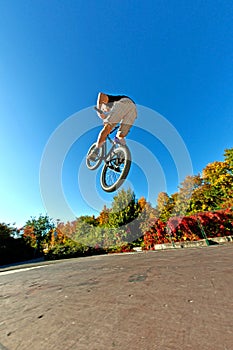 Boy jumps with his trick scooter