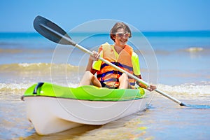 Boy on kayak in tropical sea. Kid in canoe