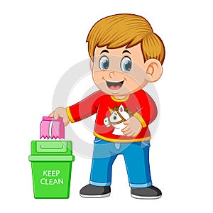 A boy keep clean environment by trush in rubbish bin